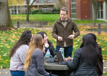 Professor of Psychology and Biology Baine Craft talks  with a few of his students from the first cohort of the Master of Science in Research Psychology program.