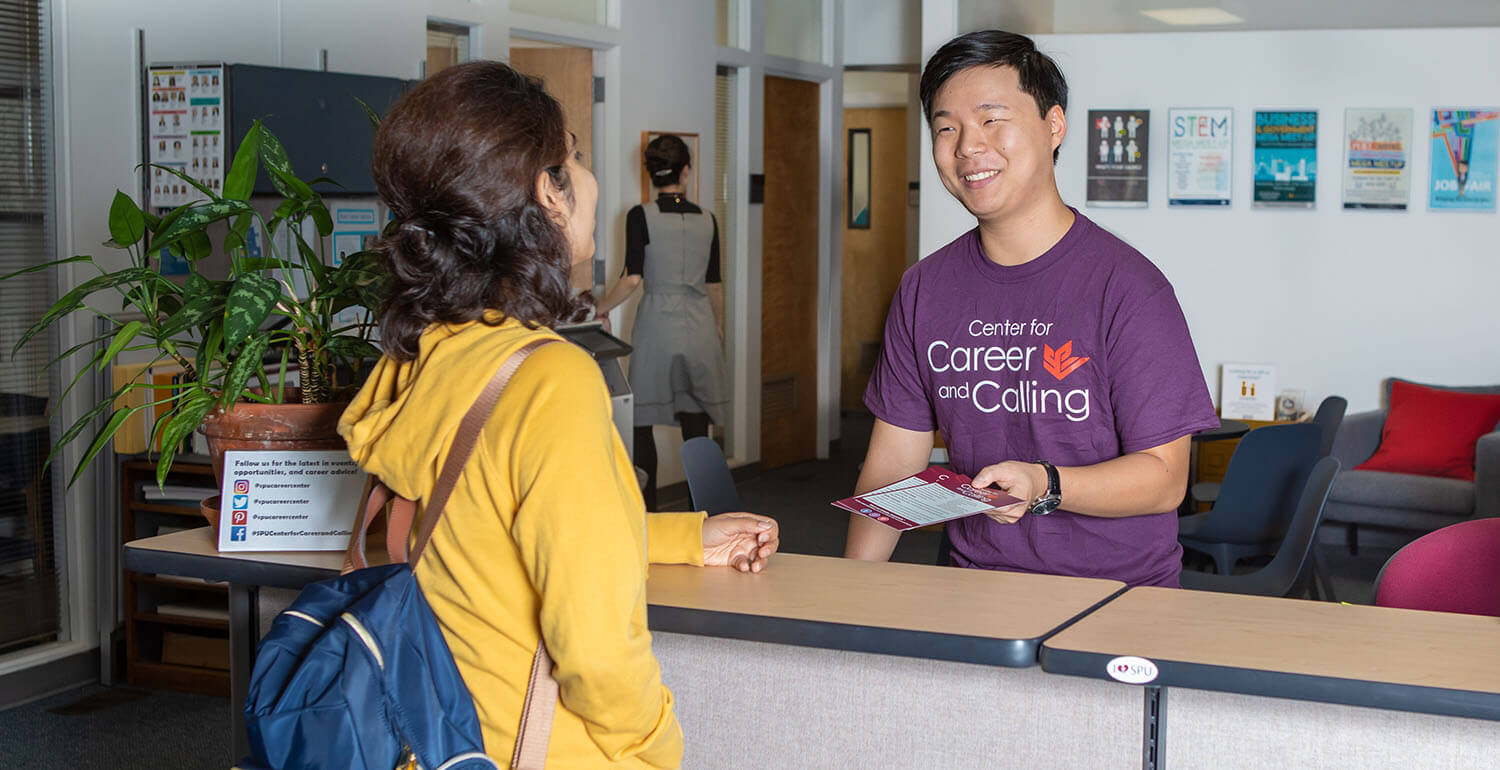 A peer career advisor greets and SPU student at the Center for Career and Calling | photo by Lynn Anselmi