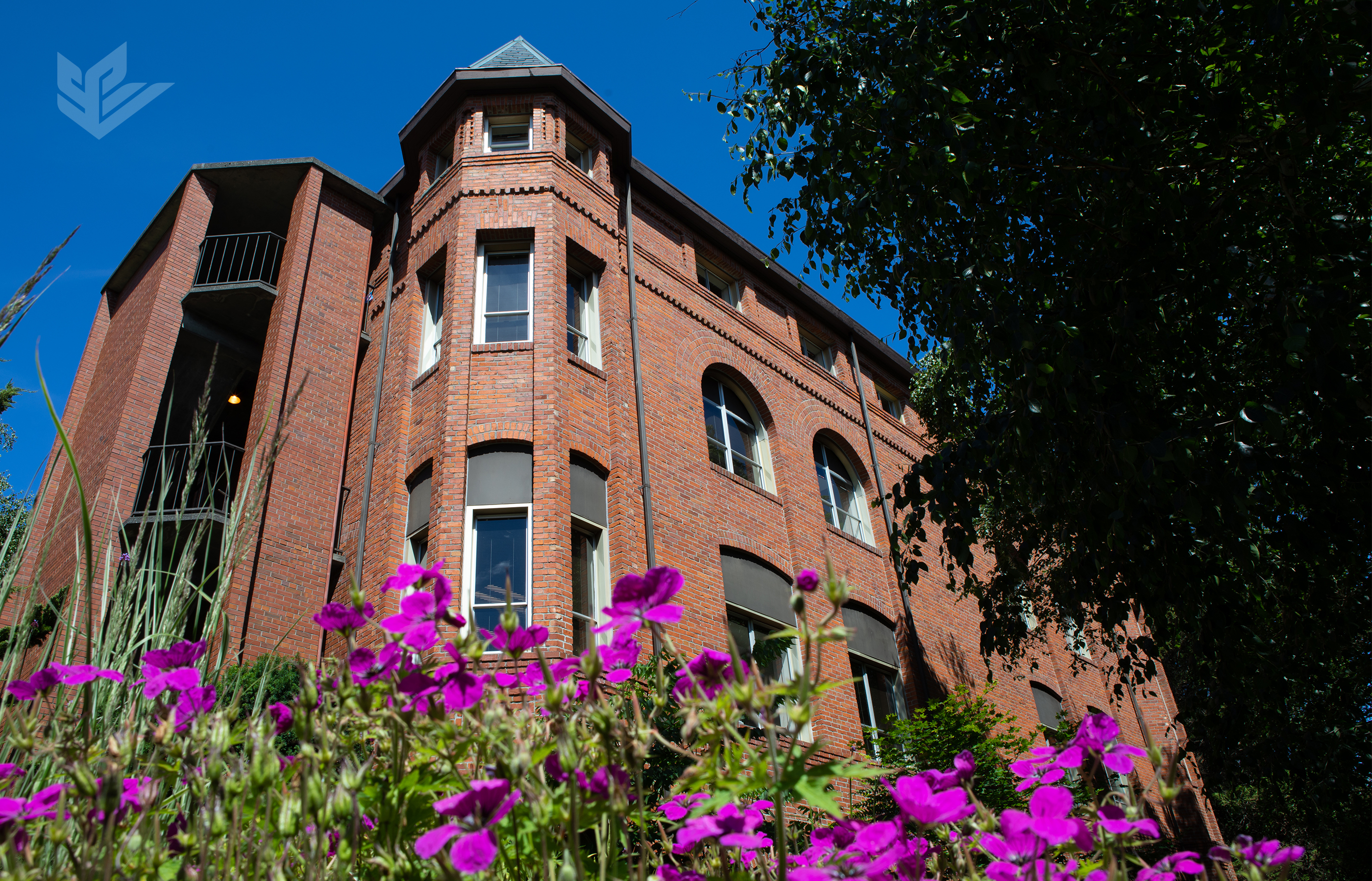 A summertime image of historic Alexander and Adelaide Hall on the Seattle Pacific University campus.