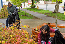 SPU's new freshman picking up leaves at a City Quest event.